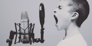Boy screaming into Microphone
